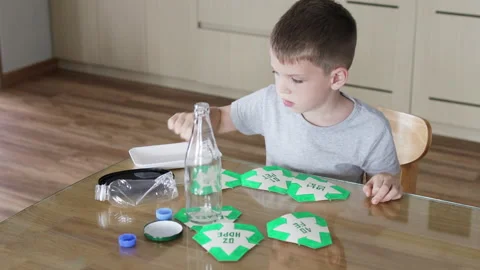 Child sorting waste at home. Stock Footage 294158062