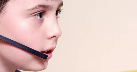 Child speaking into headset Stock Footage 79660228
