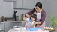 Child With Special Needs Baking With Mother Stock Footage