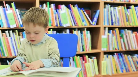 Child spending time in the library Stock Footage 211093956
