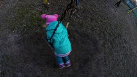 A child is spinning on a swing Stock Footage 75394161