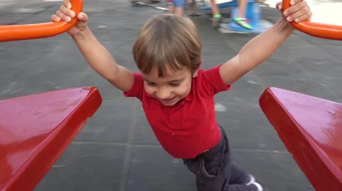 Child spins up a roundabout Stock Footage 67749175