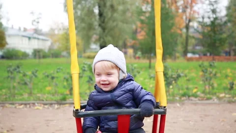 The child spins on the swing Stock Footage 142306426