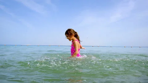A child splashes water on the sea. Selective focus. Stock Footage 153262875