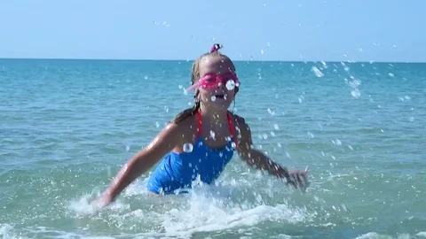 Child splashing in the sea Stock Footage 79359624