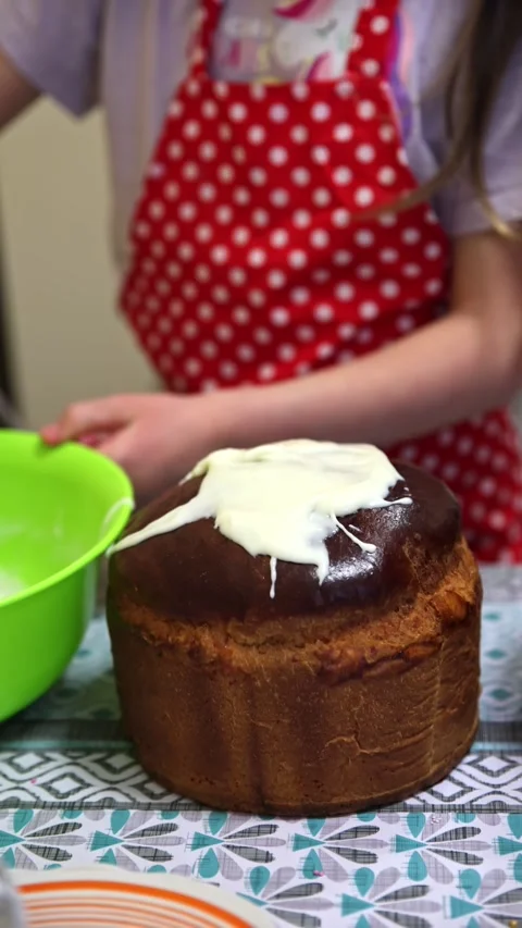 Child Spreading White Icing on Easter Kulich Paska Stock Footage 333010285