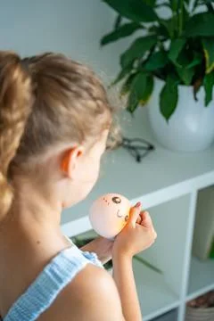 Child squeezes a soft squishy stress relief toy at home. Sensory play supports Stock Photos