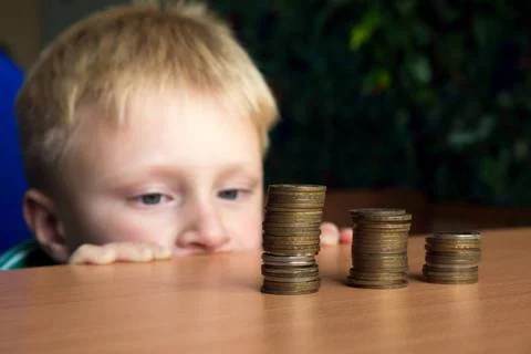 Child stacking coins child stacking coins ,model released, Symbolfoto Copy... Stock Photos