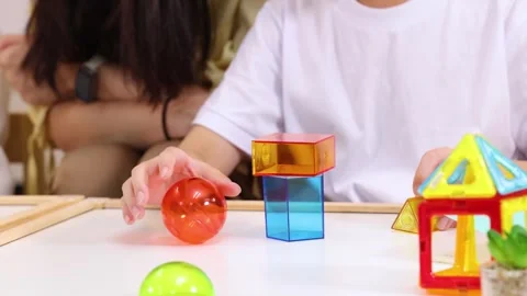 Child Stacking Colorful Blocks During Classroom STEM Activity Stock Footage 321862664