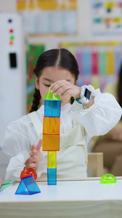Child Stacking Colorful Building Blocks in Classroom Setting Stock Footage 334640940