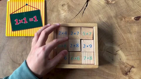 Child stacks wooden math squares with calculations Stock Footage 170999701