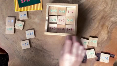 Child stacks wooden math squares with calculations Stock Footage 171007257