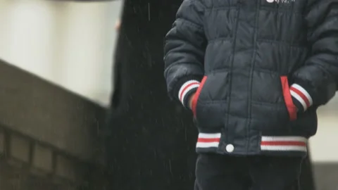 Child on the Stairs in Heavy Rain. Camera Moving Down Stock Footage 88148330