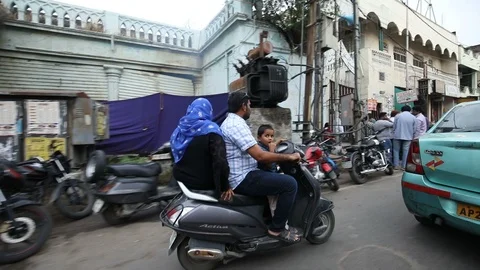 Child-standing-in-front-of-the-seat-on-two-wheeler-india Stock Footage 117949964