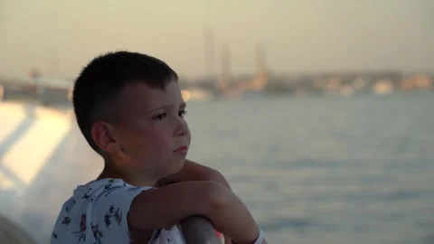 A child stands on the deck and admires the sea Stock Footage 255613174