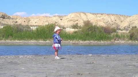 The child stands at the lake Stock Footage 96015495