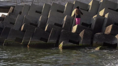 The child stands on tetrapods Stock Footage 307384367