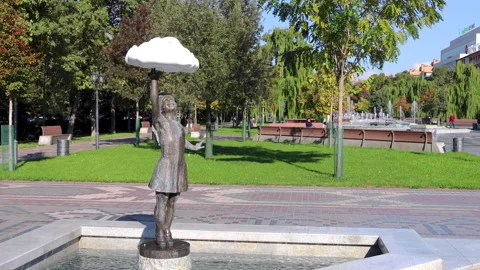 Child statue reaching cloud with water droplets Stock Footage 261577141