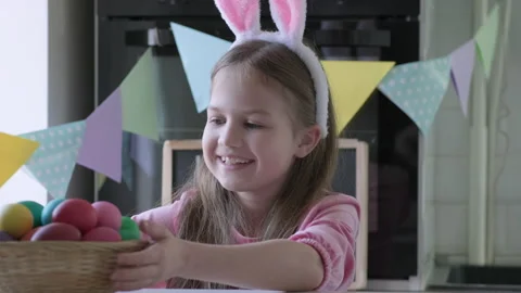 Child steals a basket of eggs from the table at Easter Day Stock-Footage 173368141