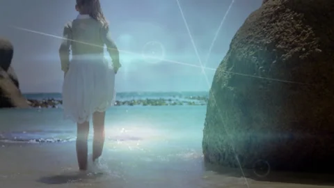 Child stepping into water's edge while swirling digital overlays demonstrating Stock Footage 311085074