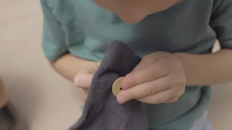 Child Stitching Small Fabric Piece, concept of micro motor training Stock Footage 321892135