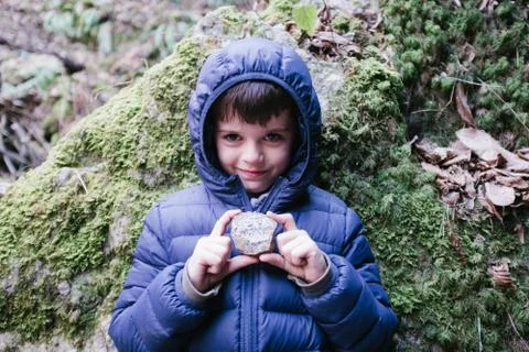 Child with stone in hand Stock Photos