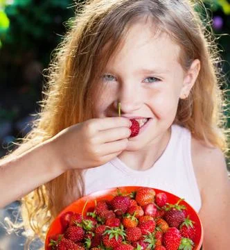 Child with strawberry Stock Photos