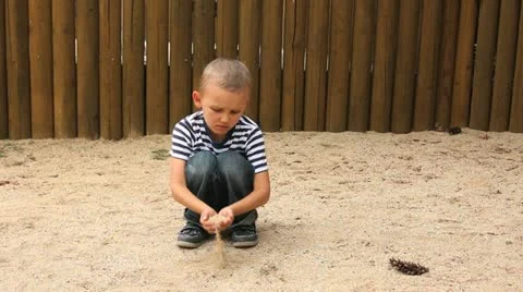 Child strews sand through hands Stock Footage 11485778