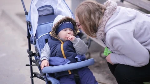 A child in a stroller eats cookies Stock Footage 116771494