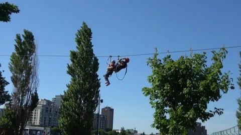 Child stuck on zip line, being rescued by adult 스톡 동영상 78231062
