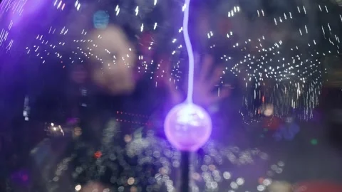 A child studies an exhibit in a museum, a ball with plasma and lightning Stock Footage 269871177