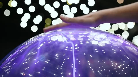 A child studies an exhibit in a museum, a ball with plasma and lightning Stock Footage 269871205