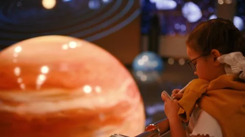 A child studies an exhibit in a museum, a planets , space Stock Footage 269870447