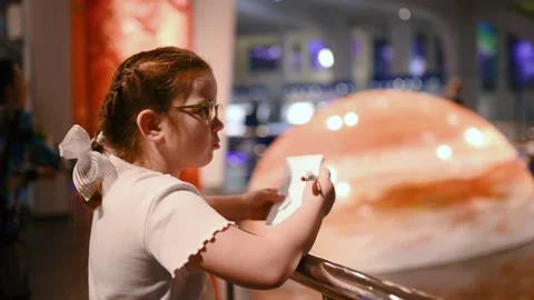 A child studies an exhibit in a museum, a planets , space Stock Footage 269870556