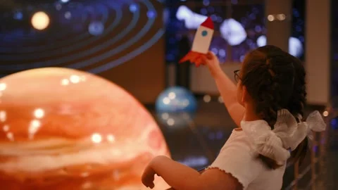 A child studies an exhibit in a museum, a planets , space Stock Footage 269870617