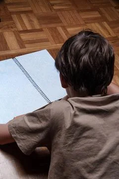 Child studies math problems in a notebook Stock-Fotos