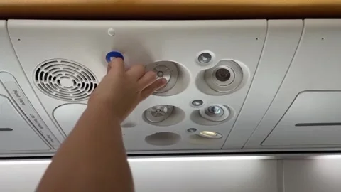 A child studies overhead panel in the cabin of an airplane Stock Footage 285315051