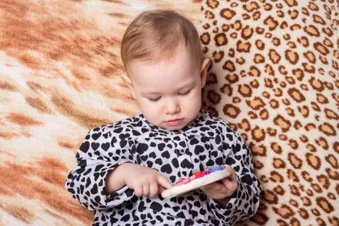 Child studies a toy Stock Photos