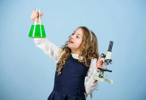 Child study bilogy lesson. Discover future. small girl scientist with testing 库存照片
