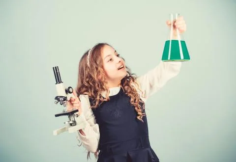 Child study bilogy lesson. Discover future. small girl scientist with testing 库存照片