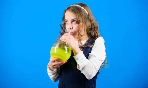 Child study bilogy lesson. small girl scientist with testing flask. education 库存照片