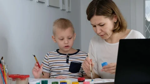 Child study online drawing with his mother via internet looking at laptop, Stock Footage 129322289