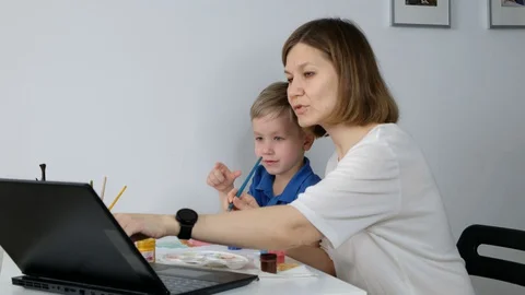 Child study online drawing with his mother via internet looking at laptop, Stock Footage 129322328