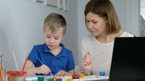 Child study online drawing with his mother via internet looking at laptop, Stock Footage 130459745