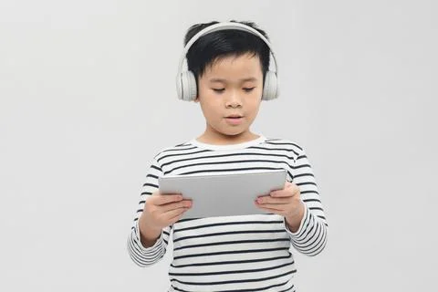 Child study online sitting with tablet and headphones. Stock Photos