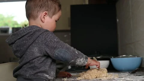 The child is studying cooking. baking and baby. The kid loves to cook Stock Footage 132731886