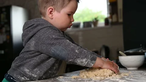 The child is studying cooking. baking and baby. The kid loves to cook Stock Footage 132731916