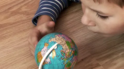 Child studying a globe Video stock 12227666