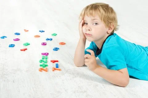 Child studying mathematics. Tired Kid Stock Photos