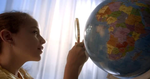 Child is studying while sitting at home in rays sun in room.Kid in morning light Stock Footage 220778063